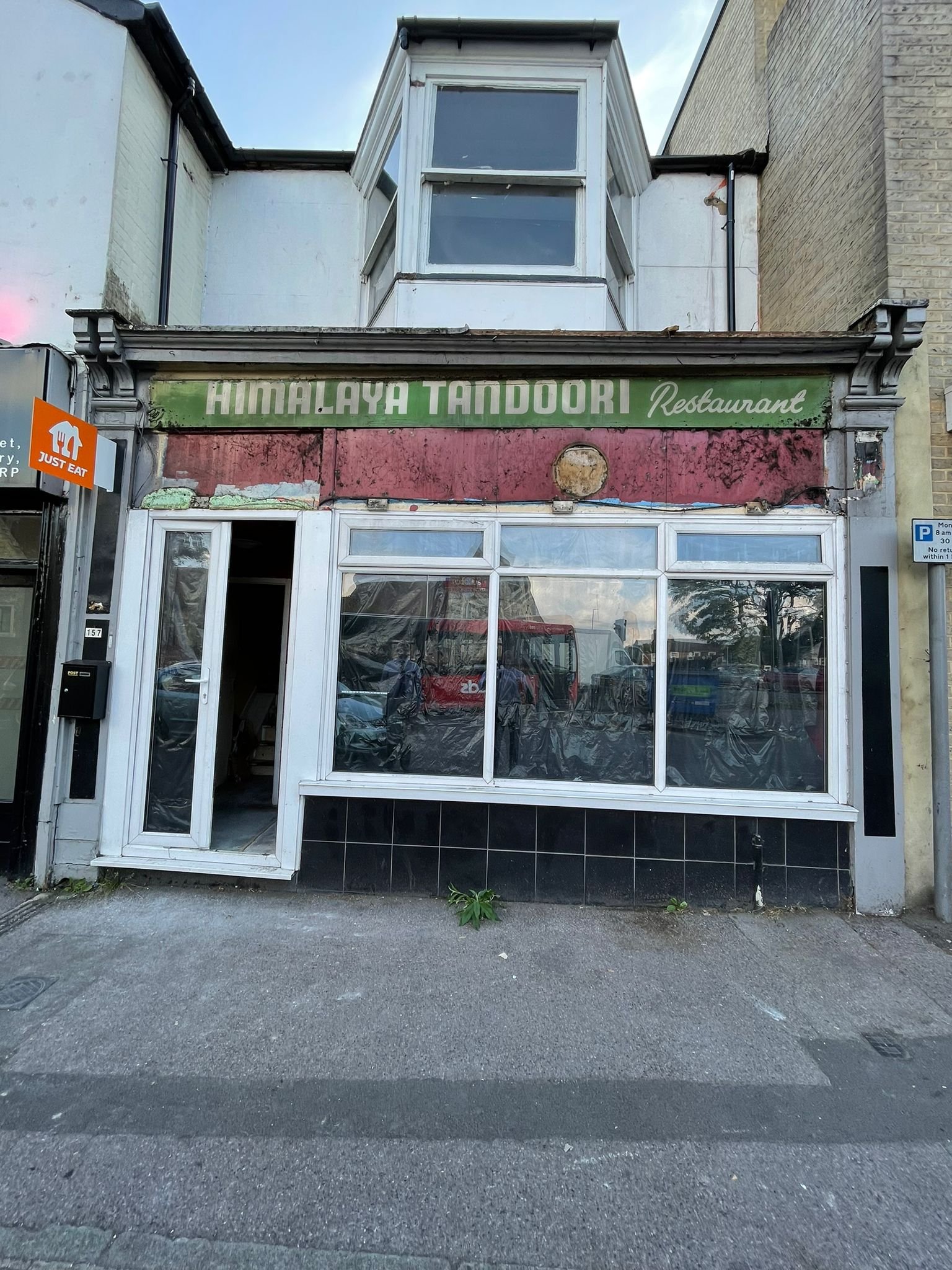 The uncovered original Himalaya Tandoori sign on a Salisbury building